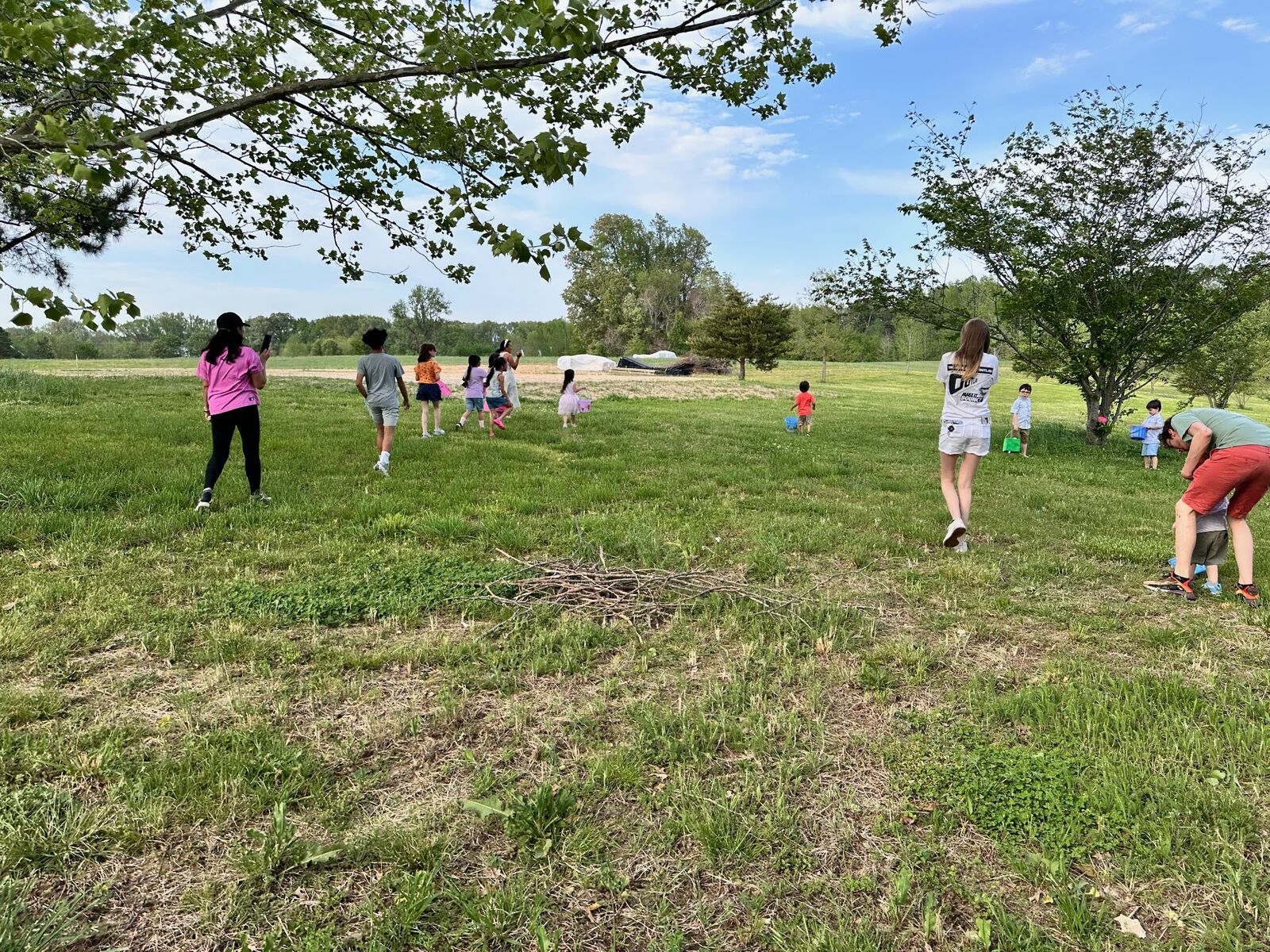 Children running across an open grassy field