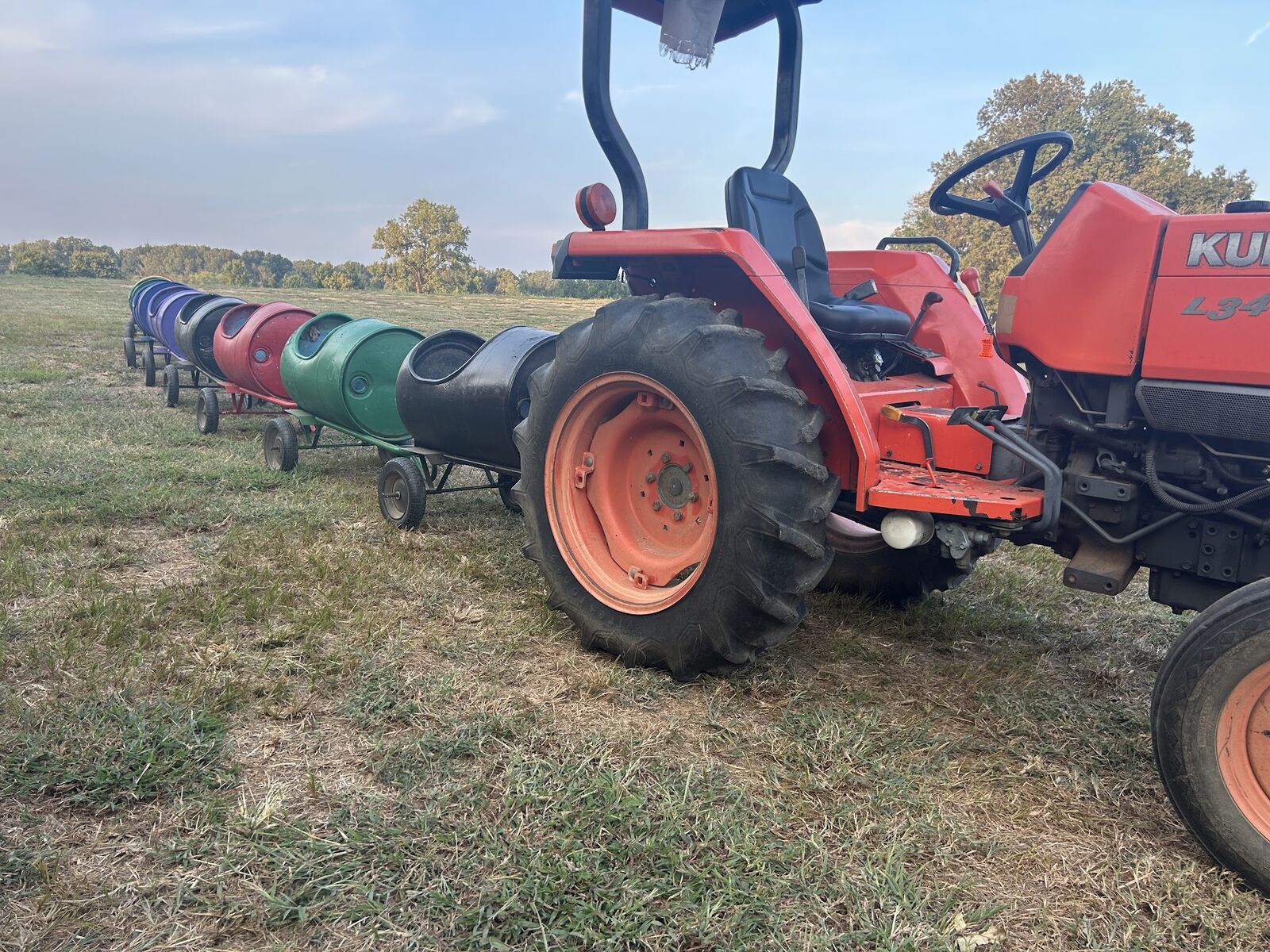 A red tractor pulling the barrel train