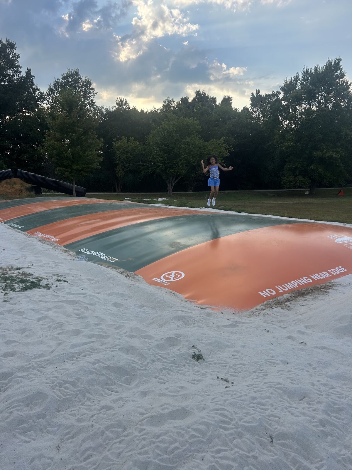 The inflatable jump pillow on a sandy area